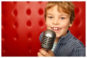 boy-with-microphone-red-background-studio